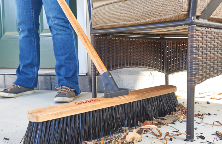 push broom sweeping porch