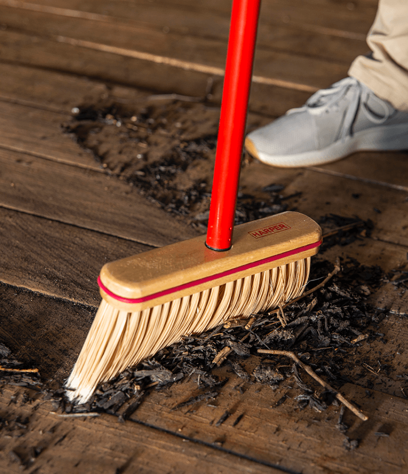 sweeping mulch with broom